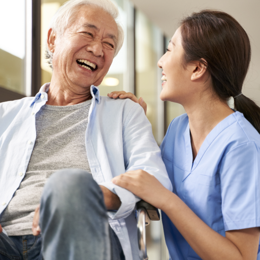 senior man and healthcare worker laughing