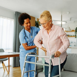 nurse assisting an elderly