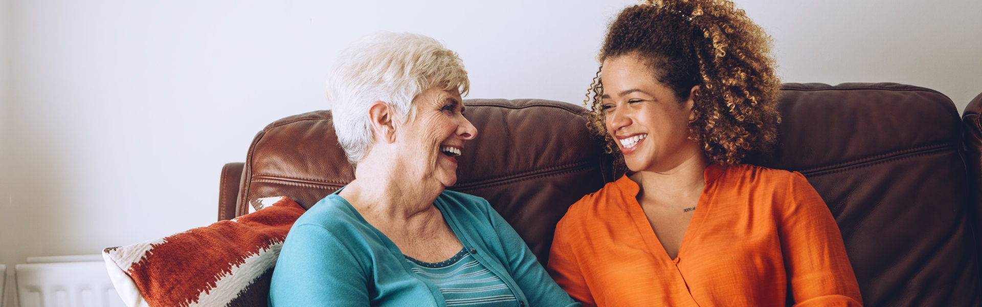 woman and elderly smiling at each other