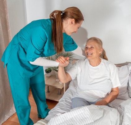 healthcare worker and elderly smiling